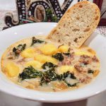 Creamy Italian soup filled with sausage, bacon, gnocchi, and kale in a ceramic farmhouse style soup bowl.